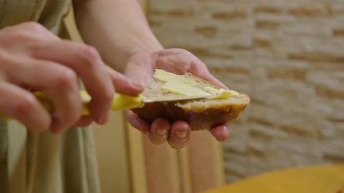 Close up Spreading Butter on Bread with Knife