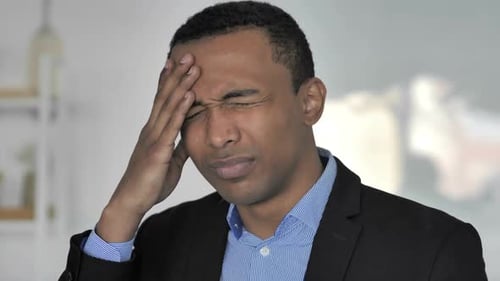 Headache Portrait of Tense Casual AfroAmerican Businessman in Office