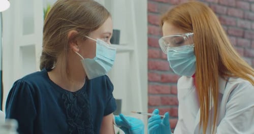 Child Receives Injection from Medical Professional Indoors