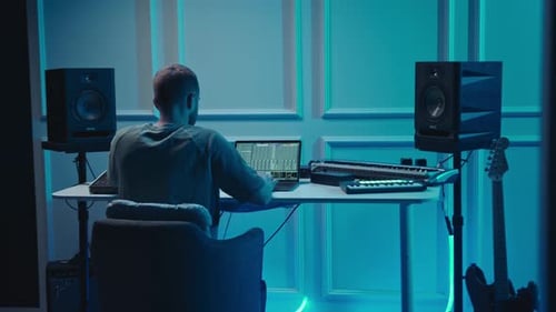 Music production studio. Producer. Man working in the recording studio with computer and mixer