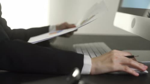 Business Woman Looking Document With Working On Computer