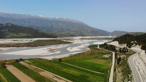 Aerial Drone Footage View Flight Over Mountain with Forests Fields and River in Sunrise Soft Light