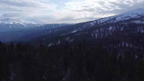 View of the beautiful snow-capped mountains on a winter day. Drone camera.