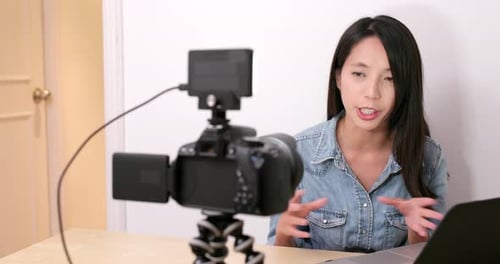 Woman Talking to Camera with Laptop