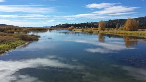 Flying low over glassy pond in Wyoming