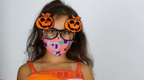 Happy Child Poses with Balloons Wearing Halloween Costume