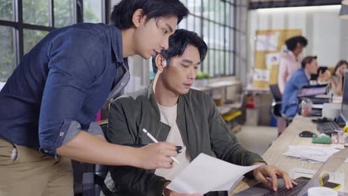 Two Men Collaborating on Project in a Modern Office