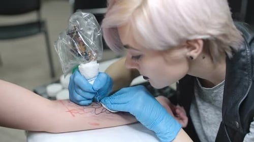 Tattoo Artist Creating Detailed Tattoo on Arm