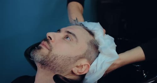 Man Gets Hair Washed at Upscale Barber Shop