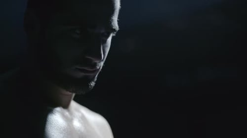 Sad Sporstman Contemplating in Dark
