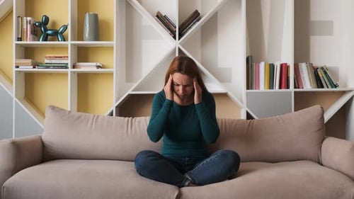 Young Woman Massaging Her Forehead From a Side As She Having Bad Headache