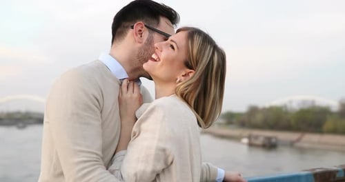 Couple Embracing and Laughing By the River