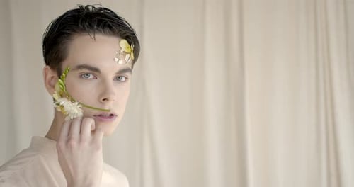 Young Adult with Flowers on Face Beauty