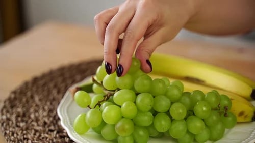 Close Up of Green Grapes and Bananas in Plate on Kitchen Table
