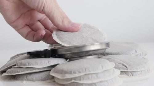 Hand Placed Coffee Pod on Metal Filter