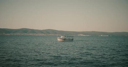 Motorboat Traveling on Rippling Ocean Water on Overcast Day