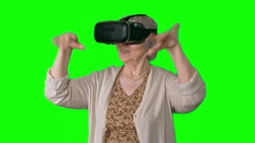 Senior Woman Using VR Headset on Green Screen