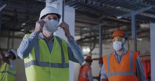 Engineer Talking with Worker During Pandemic