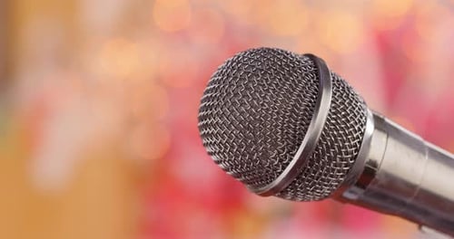 Microphone on Stage Against a Blurry Light ,Blurry Background.
