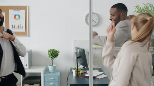 Attractive African American Guy in Suit Having Fun Dancing with Colleagues in Office