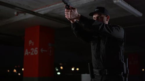 Police Officer Aiming a Gun in a Parking Garage
