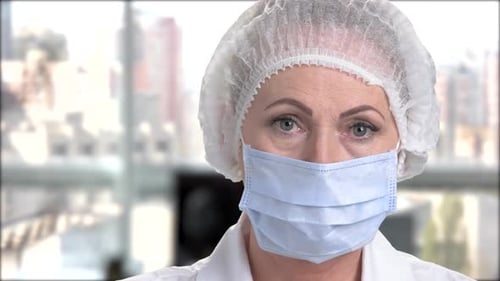 Woman Doctor Wearing Mask, Hairnet in Hospital