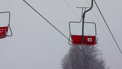 View of the Ski Lift Against the Background of a Mountain Forest and Gray Sky in the Carpathians