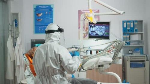 Dentists Provide Patient Treatment in Modern Office