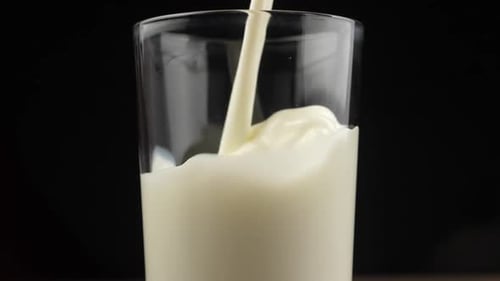SLOW MOTION: Pouring milk in the glass