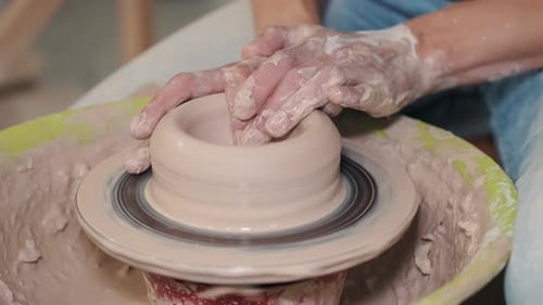 Close Up of Female Potters Hands Making Bowl
