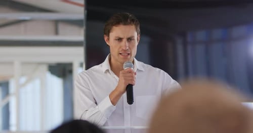 Professional Man Giving Presentation at Corporate Event
