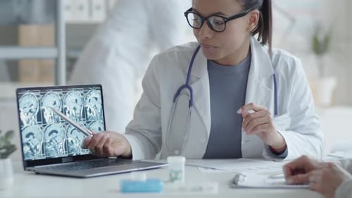 Doctor Explains Brain Scan to Patient in Office