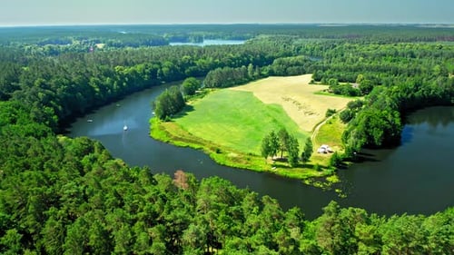 Small white boat on river between the forests, Poland