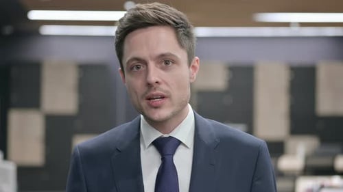 Businessman Giving a Presentation in Office Setting