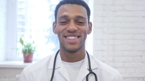 Smiling Happy African American Doctor Looking at Camera in Clinic