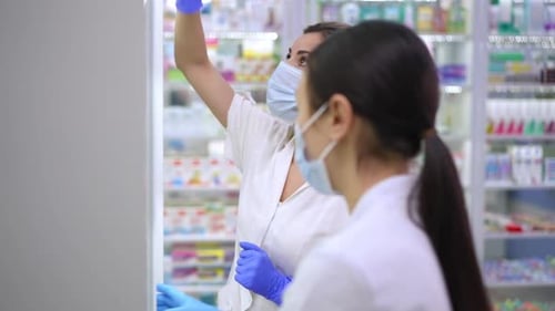 Pharmacists Wearing Masks Working in Pharmacy