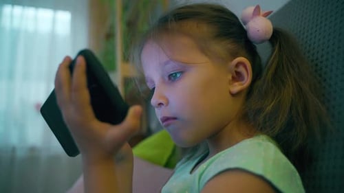 Girl Uses Smartphone Indoors at Home