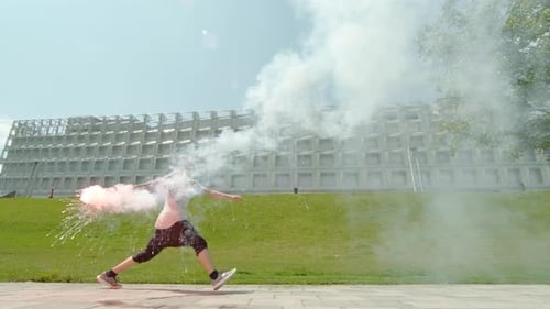 Teen Runs with Sparks in Front of Building