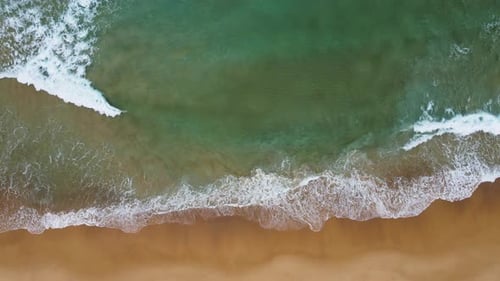 Aerial view of white sand beach and ocean wave