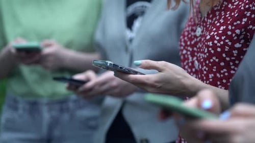 Group of People Using Smartphones in Urban Setting