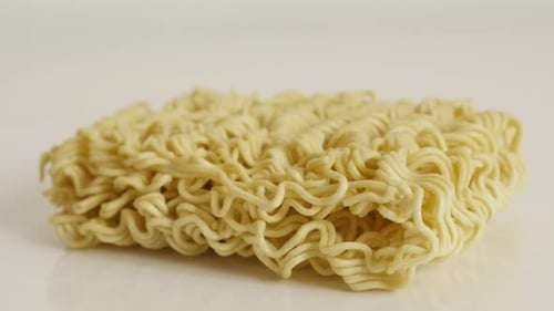 Chinese type noodles close-up 4K 2160p 30fps UltraHD tilting footage - Instant staple food block s