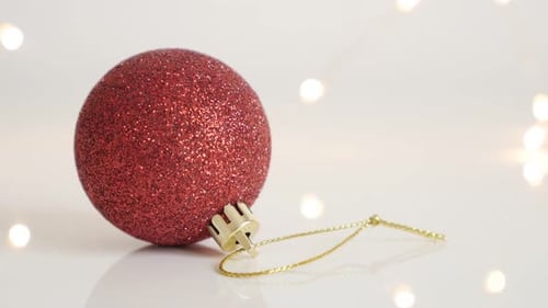 Decorative red bauble with sequins close-up 4K 2160p 30fps UltraHD footage - Shiny Christmas ornamen