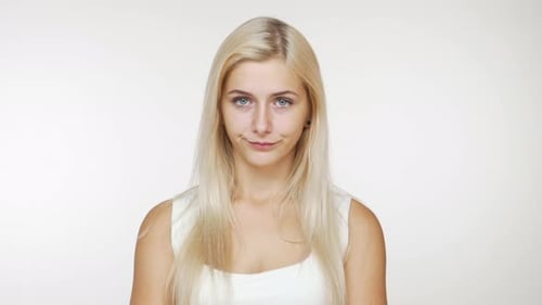 Woman with Blonde Hair Smiles at the Camera