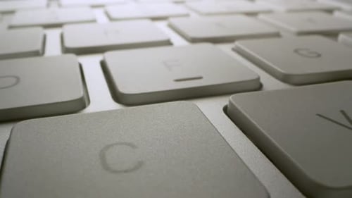 Macro wide angle view of computer keyboard moving over the buttons