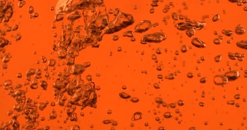Bubbles Rising in Orange Liquid