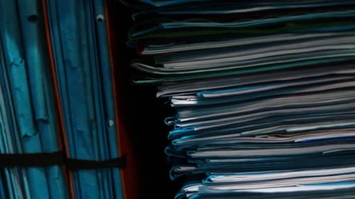 Stacks of Paperwork and Files in Office