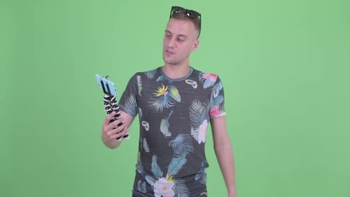 Happy Handsome Man with Sunglasses Vlogging and Showing Phone