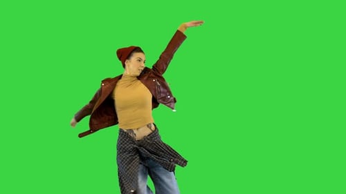 Young Girl in Urban Dance Clothes Makes a Turn and Runs Away on a Green Screen Chroma Key