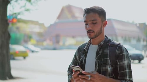 Man hailing taxi while talking on phone