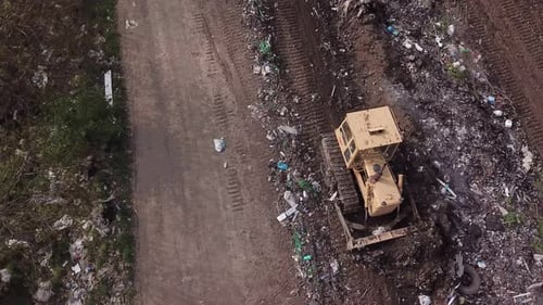 Bulldozer Shovels Rubbish in One Pile